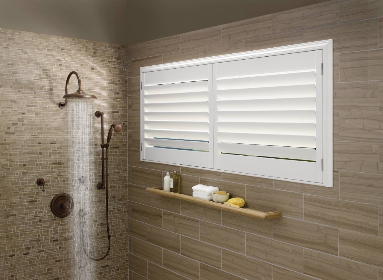 Shower with tan tile and white Hunter Douglas Palm Beach™ Polysatin™ shutters near Fort Mill, SC